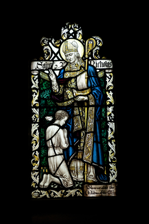 Detail of a stained glass window with Saint Nicholas and a child in Crowland Abbey, Crowland, Lincolnshire, England - 27th April 2013のeditorial素材