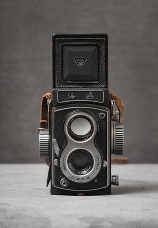 A Seagull 4 TLR Twin Lens Reflex Camera with brown strap with a grey background, Nottingham, UK - January 2018のeditorial素材