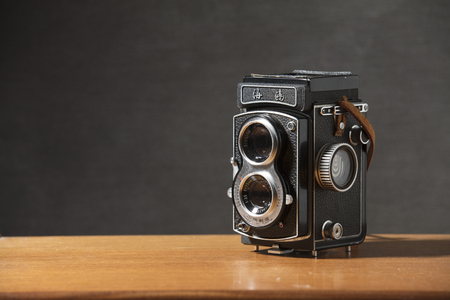A Seagull 4 TLR Twin Lens Reflex Camera with brown strap on a table with a grey background, Nottingham, UK - January 2018のeditorial素材