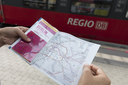 Potsdam, Berlin, Germany: 18th August 2018: Tourist looking at Marco Polo Guide and Public transport mapのeditorial素材