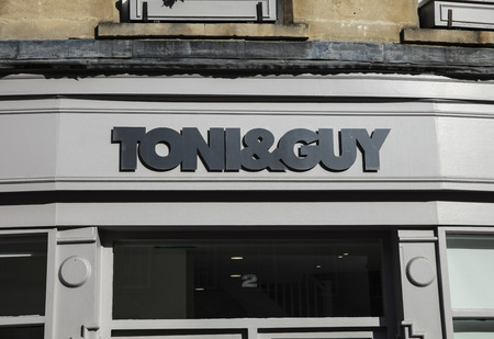 Bath, Somerset, UK, 22nd February 2019, Shop Sign for Toni and Guys Hairdressersのeditorial素材