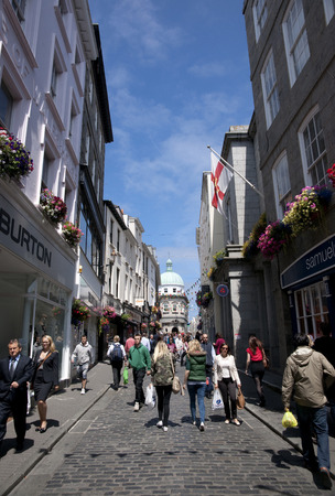 a High Street in the town of St Pierre Port (St Peter Port), the main settlement of Guernsey, The Channel Islands, UK - 11th July 2013のeditorial素材