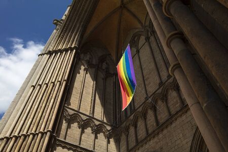 Peterborough, Cambridgeshire, United Kingdom, July 2019, A view of a Pride flag hanging from Peterborough Cathedralのeditorial素材