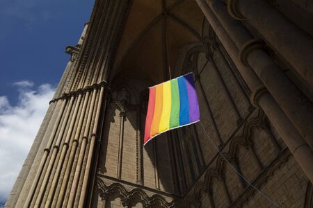 Peterborough, Cambridgeshire, United Kingdom, July 2019, A view of a Pride flag hanging from Peterborough Cathedralのeditorial素材