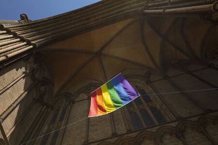 Peterborough, Cambridgeshire, United Kingdom, July 2019, A view of a Pride flag hanging from Peterborough Cathedralのeditorial素材