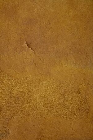 yellow ochre Textured Rendered Wall - Stucco / Fresco effect with small ripples and chips