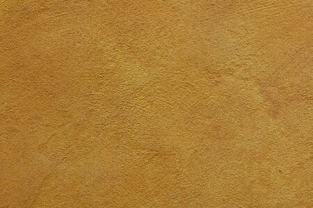yellow ochre Textured Rendered Wall - Stucco / Fresco effect with small ripples and chipsの写真素材