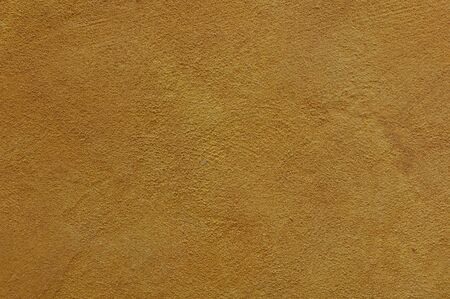 yellow ochre Textured Rendered Wall - Stucco / Fresco effect with small ripples and chipsの写真素材