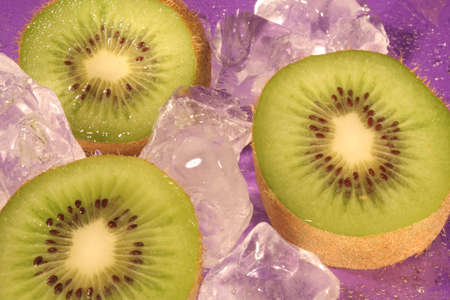 Ice and Kiwi Fruit on purple backgroundの写真素材