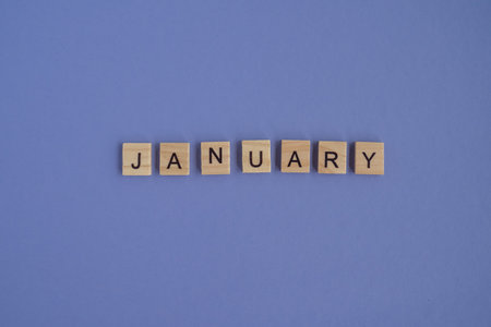 The first month of the year JANUARY -from isolated letters on wooden blocks in natural color, in high resolution. Very Peri background, copy space. Flat lay, step by step, step1の写真素材