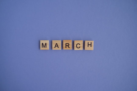 The third month of the year MARCH - from isolated letters on wooden blocks in natural color, in high resolution. Very Peri Color of the Year background, copy space. Flat lay, step by step, step 3.の写真素材