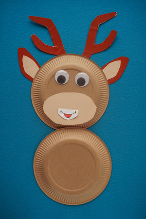 Christmas New Year Santas deer handmade. Step by step photo instruction. DIY concept. Step 8-13. Take the funny eyes and glue them over the deers face. Top view, Flat layの写真素材