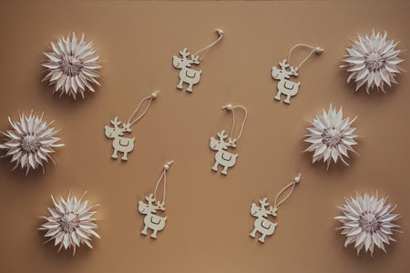 Paper flowers origami and deers from old newspapers and splinters close-up view from above. DIY from...