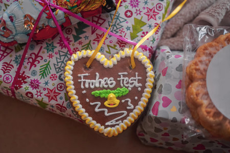 Christmas gingerbread with yellow cream on the festive packaging with gifts close-up. Christmas cozy atmosphere. Festive fair. Gingerbread and gifts. selective focusの写真素材