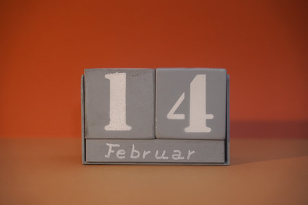 Feb 14 on wooden gray cubes. Calendar cube date 14 Feb. concept date. Copy space for text or event. Educational cubes. Cube shape calendar for February 14 with empty space. selective focusの写真素材