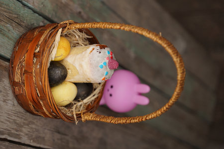 Rabbit with Easter eggs on wooden background. selective focus