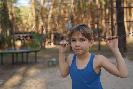Cute boy having fun on outdoor playground. Summer active sport leisure for child. Outdoor activities for family with children. Equipment for entertainment park.の写真素材
