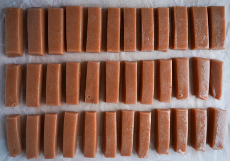 sweet factory. Conveyor belt with candy close-up top view.
