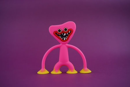 Pink monster chef holding on to the ground on viva magenta backgroundの写真素材
