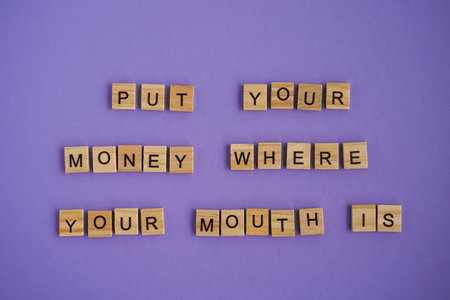 Sayings Put your money where your mouth is on Very Peri background.の写真素材
