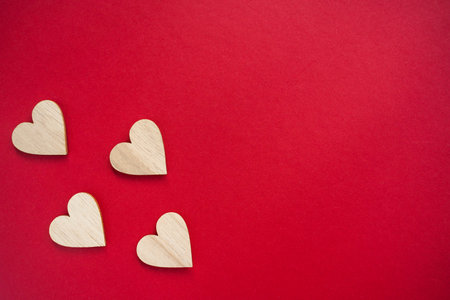 Four wooden hearts placed on viva magenta background. top view. Flat lay copy spaceの写真素材