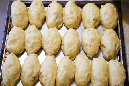 Raw pies on a baking sheet, top view.の写真素材