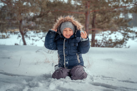 Portrait of happy child in winter forest