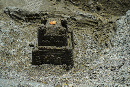 Castle in the sand. Summer children's games. Children's sand castle close upの写真素材