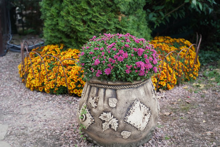 A huge flower pot in the form of an old bag. original garden decor