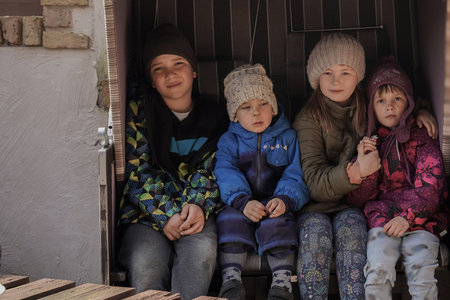 Poor children sit in the slums of Chile. Poverty is a major issue in Argentina. World poverty and hunger, problems of developing countriesの写真素材