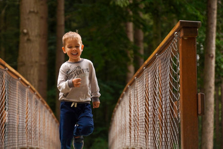 A little boy runs merrily through the forestの写真素材