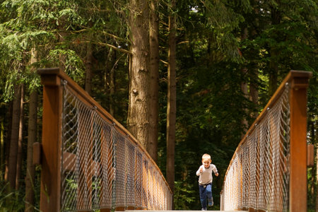 A little boy runs along a forest path. A small athlete, the will to winの写真素材