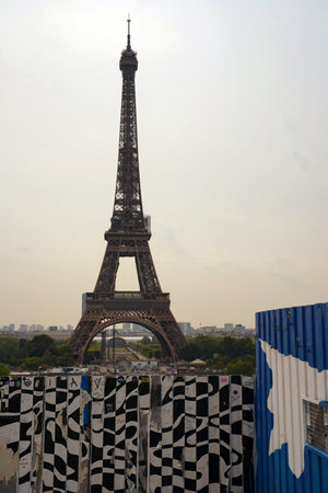 Paris, France-07-22-22: Eiffel Tower, view from behind a fence painted graffitiのeditorial素材