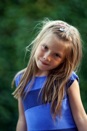 A girl with disheveled hair and smeared with chocolate. A fun childhoodの写真素材