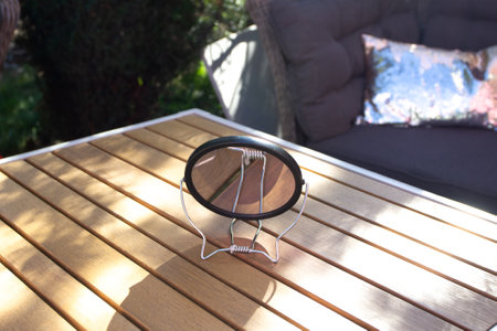 round makeup mirror stands on a turnip table.の写真素材