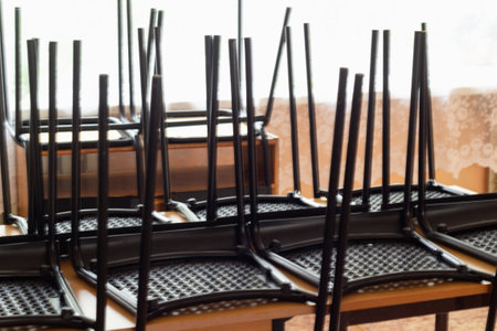 Overturned black chairs classroom agains window inの写真素材