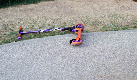 child scooter thrown the ground lies playground