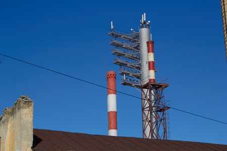 Pipes and floodlights on the background blue sky.の写真素材
