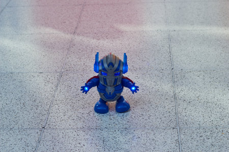 A blue robot on a gray floor background. Toys for children on the remote control. Games for boys.の写真素材