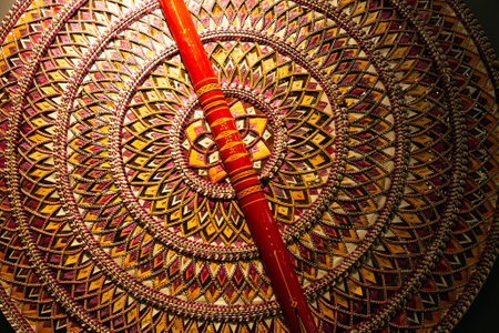 handmade Indian panel and a bright red wooden stick.