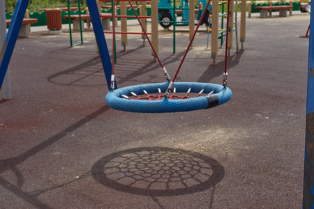 A playground on the street. Hanging swingの写真素材