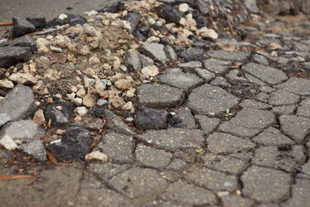 Close up of cracks in the asphalt surface,