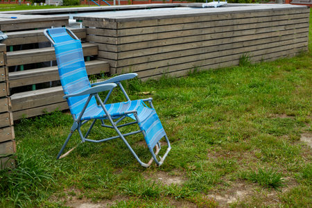 a blue chaise longue chair by the country pool.