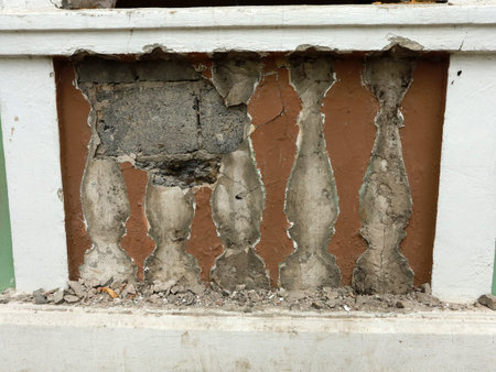 a fragment of the building destroyed stucco balusters under the windowの写真素材