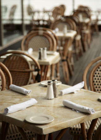 restaurant table chair napkin plate salt peper rowの写真素材