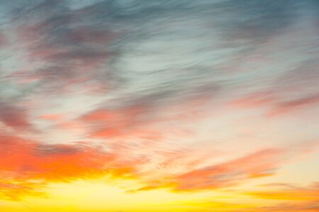 Wonderful red golden sky with clouds, sundown sunrise wallpaper backgroundの写真素材