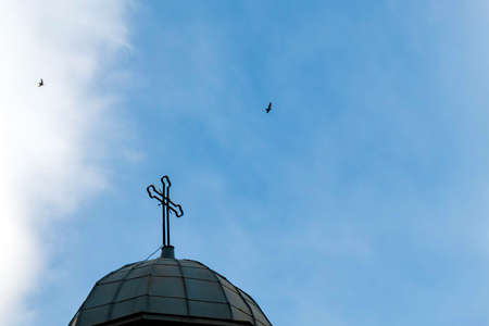 Cross of orthodox church in Bulgaria on blue sky