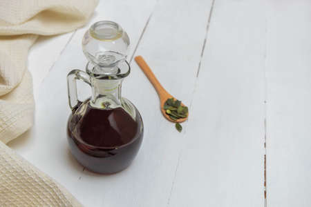 Pumpkin seed oil in a glass bottle with pupkin seedsの写真素材