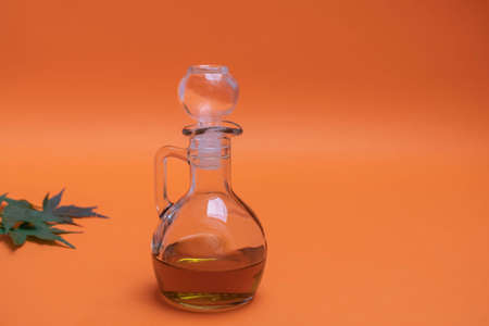 Glass jar of cannabis (marijuana) oil on orange backgroundの写真素材