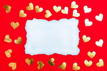 Valentines Day greeting card with empty list of paper and golden hearts on red backgroundの写真素材